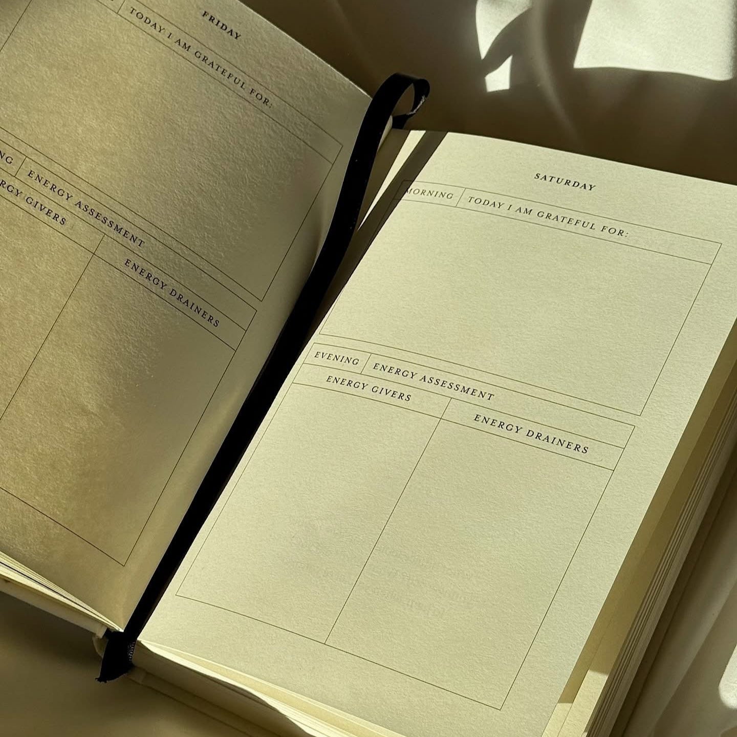 Open notebook with daily schedule entries on beige paper